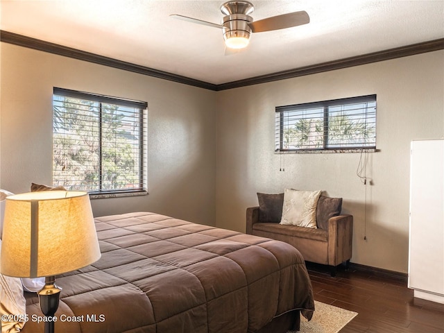1277 S Orlando Ave Unit 4B, Cocoa Beach, FL 32931 - bedroom featuring dark wood-type flooring, ornamental molding, and a ceiling fan
