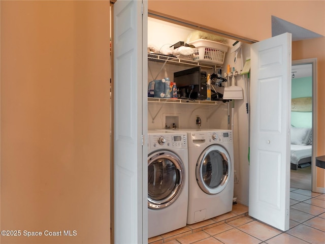 1277 S Orlando Ave Unit 4B, Cocoa Beach, FL 32931 - laundry room featuring washer and clothes dryer and light tile patterned floors