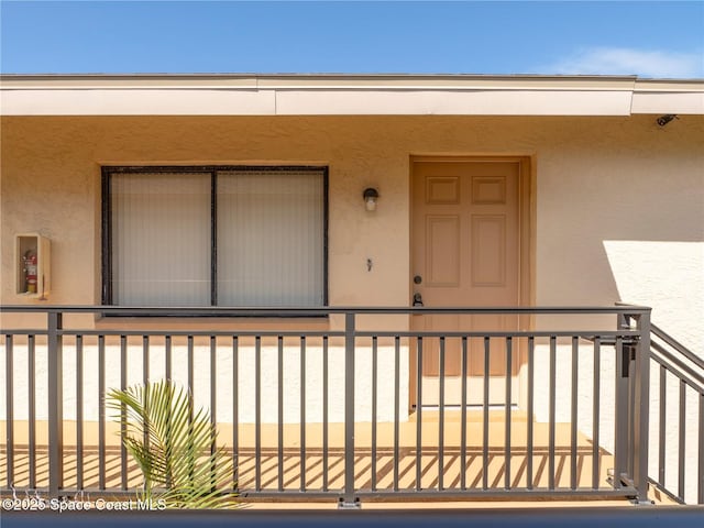 1277 S Orlando Ave Unit 4B, Cocoa Beach, FL 32931 - doorway to property featuring stucco siding