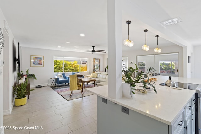 208 Atlantic Blvd, Indian Harbour Beach, FL 32937 - kitchen featuring open floor plan, stove, a ceiling fan, hanging light fixtures, and light stone countertops