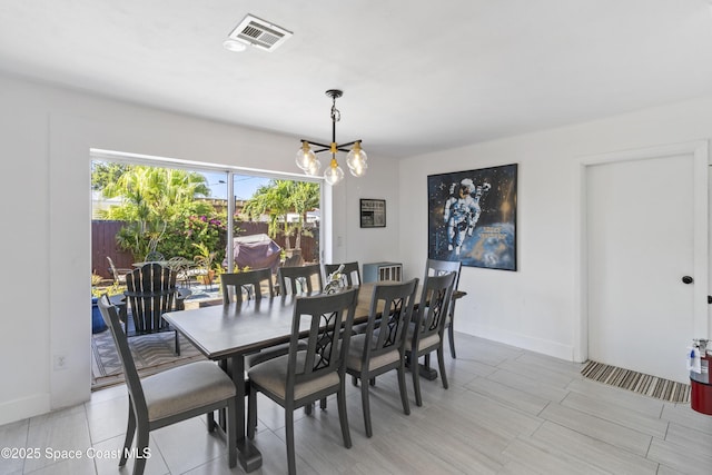 208 Atlantic Blvd, Indian Harbour Beach, FL 32937 - dining space with a chandelier and baseboards
