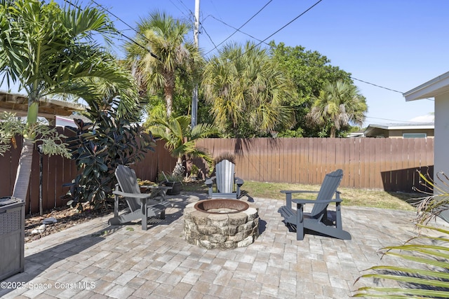 208 Atlantic Blvd, Indian Harbour Beach, FL 32937 - fenced backyard featuring an outdoor fire pit and a patio