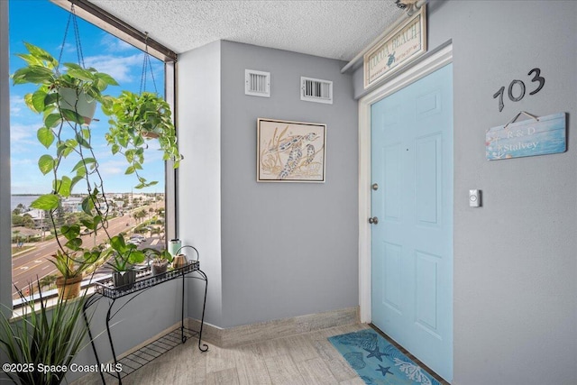 3221 S Atlantic Ave Unit 703, Cocoa Beach, FL 32931 - foyer entrance featuring a wall of windows and a textured ceiling