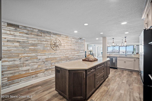 3221 S Atlantic Ave Unit 703, Cocoa Beach, FL 32931 - kitchen featuring dishwasher, dark brown cabinets, light countertops, recessed lighting, and light wood-style floors