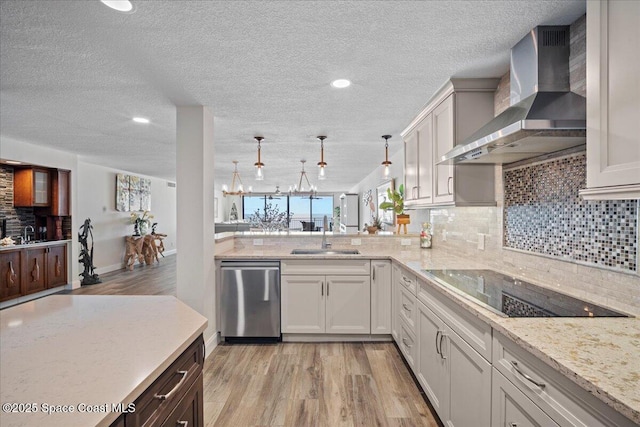 3221 S Atlantic Ave Unit 703, Cocoa Beach, FL 32931 - kitchen with wall chimney exhaust hood, dishwasher, black electric stovetop, light wood-type flooring, and a textured ceiling