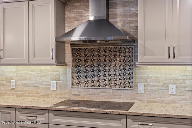 3221 S Atlantic Ave Unit 703, Cocoa Beach, FL 32931 - kitchen featuring wall chimney range hood, black electric cooktop, decorative backsplash, and light stone counters