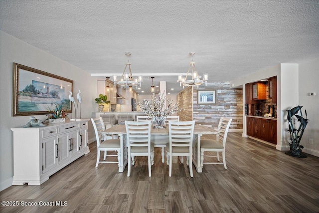 3221 S Atlantic Ave Unit 703, Cocoa Beach, FL 32931 - dining area with wood finished floors, a chandelier, and a textured ceiling
