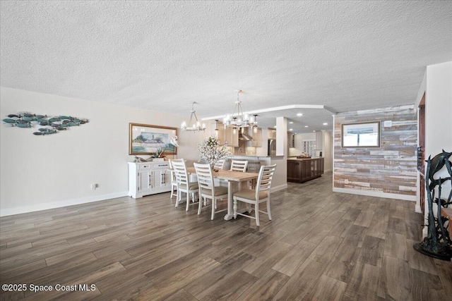 3221 S Atlantic Ave Unit 703, Cocoa Beach, FL 32931 - dining area with dark wood-type flooring, a chandelier, and a textured ceiling