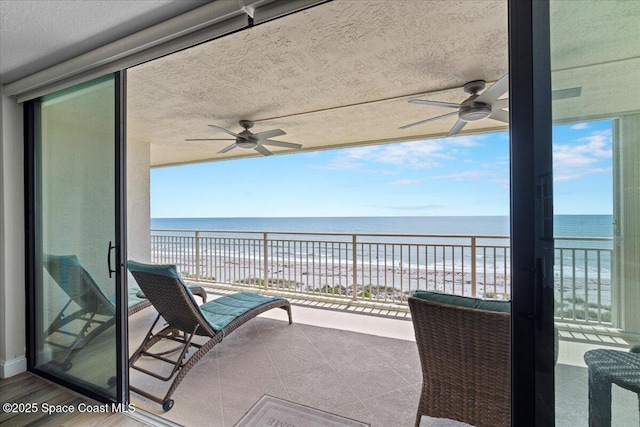 3221 S Atlantic Ave Unit 703, Cocoa Beach, FL 32931 - balcony featuring ceiling fan and view of water and beach