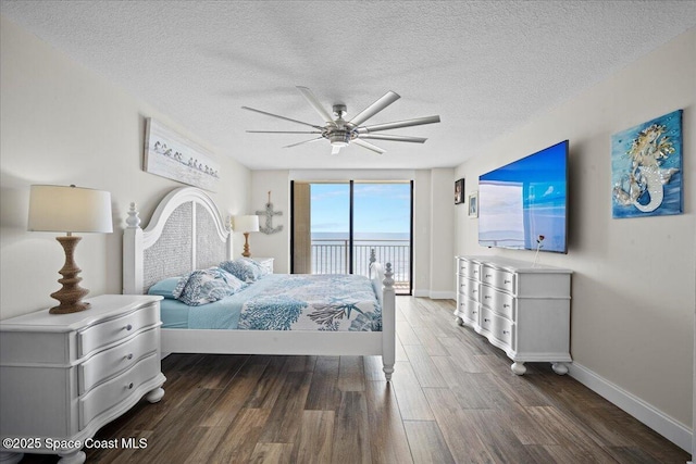 3221 S Atlantic Ave Unit 703, Cocoa Beach, FL 32931 - bedroom featuring access to exterior, wood finished floors, a textured ceiling, and ceiling fan
