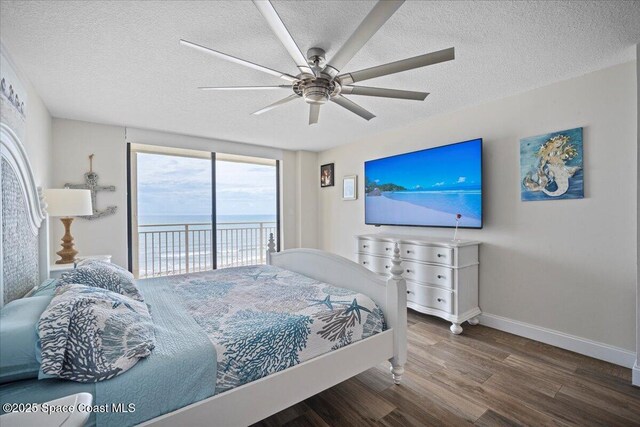 3221 S Atlantic Ave Unit 703, Cocoa Beach, FL 32931 - bedroom featuring access to outside, wood finished floors, a textured ceiling, and a ceiling fan