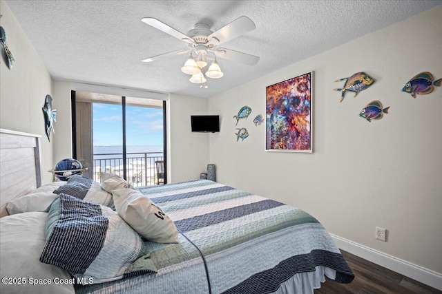 3221 S Atlantic Ave Unit 703, Cocoa Beach, FL 32931 - bedroom with access to outside, wood finished floors, a textured ceiling, and a ceiling fan