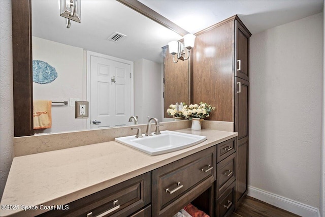 3221 S Atlantic Ave Unit 703, Cocoa Beach, FL 32931 - bathroom featuring vanity and wood finished floors