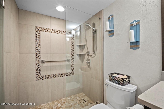 3221 S Atlantic Ave Unit 703, Cocoa Beach, FL 32931 - bathroom with a walk in shower, a textured wall, and vanity