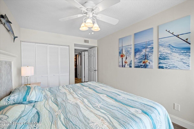 3221 S Atlantic Ave Unit 703, Cocoa Beach, FL 32931 - bedroom with a closet, a textured ceiling, wood finished floors, and ceiling fan