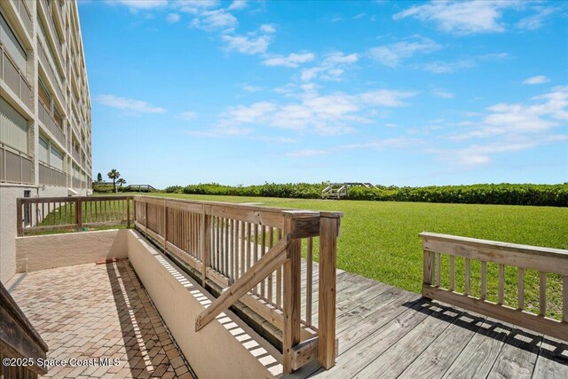 3221 S Atlantic Ave Unit 703, Cocoa Beach, FL 32931 - wooden deck featuring a yard