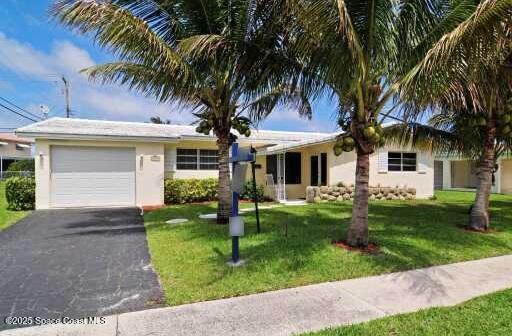 1310 SW 9th Ter, Boca Raton, FL 33428 - single story home with an attached garage, asphalt driveway, a front yard, and stucco siding