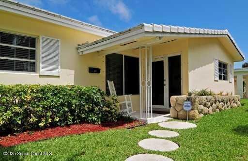 1310 SW 9th Ter, Boca Raton, FL 33428 - rear view of house featuring stucco siding, a yard, and french doors