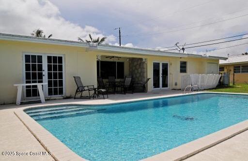 1310 SW 9th Ter, Boca Raton, FL 33428 - outdoor pool with french doors and a patio