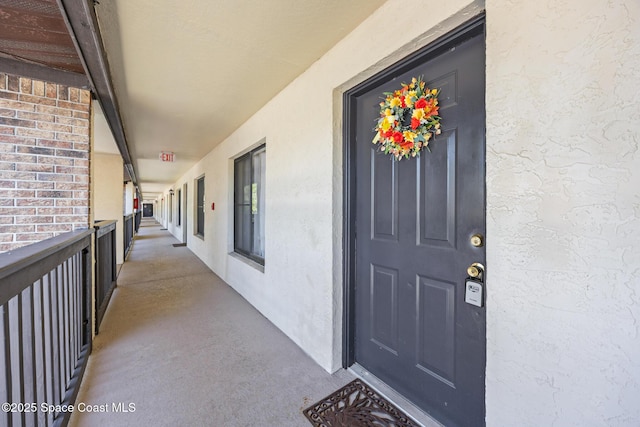 1515 Huntington Ln Unit 227, Rockledge, FL 32955 - doorway to property with stucco siding and a balcony