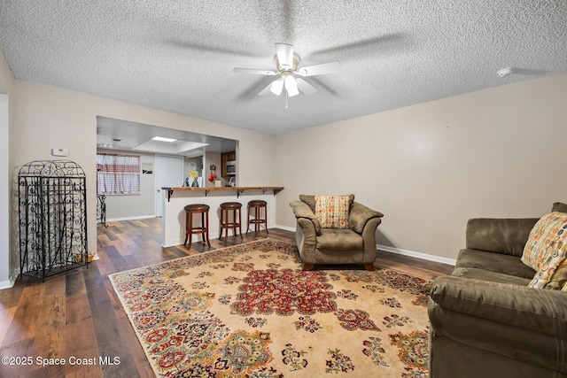 1515 Huntington Ln Unit 227, Rockledge, FL 32955 - living room with dark wood-type flooring, ceiling fan, and a textured ceiling