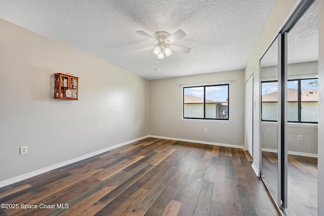 1515 Huntington Ln Unit 227, Rockledge, FL 32955 - empty room with ceiling fan, healthy amount of natural light, dark wood-style floors, and a textured ceiling