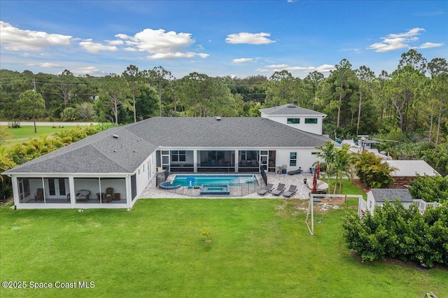 6190 Brabrook Ave, Grant, FL 32949 - rear view of house with a sunroom, an outdoor pool, a patio area, and a lawn