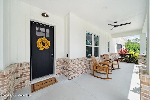 6190 Brabrook Ave, Grant, FL 32949 - property entrance with covered porch, a ceiling fan, brick siding, and board and batten siding