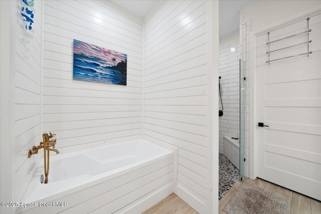 6190 Brabrook Ave, Grant, FL 32949 - bathroom with a garden tub, a shower stall, and wood finished floors