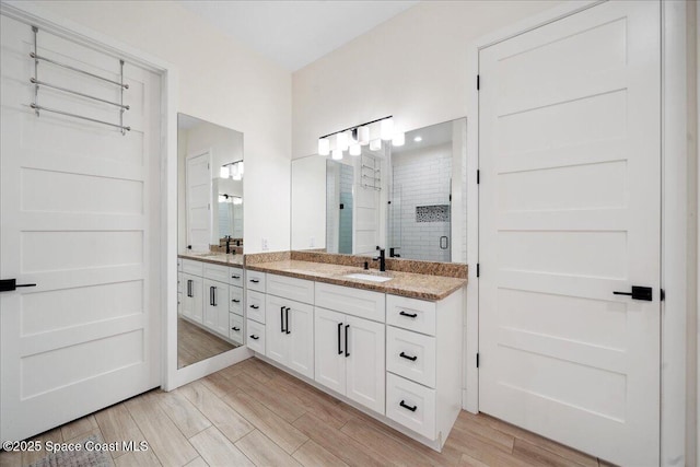 6190 Brabrook Ave, Grant, FL 32949 - bathroom featuring double vanity, a shower stall, and wood finished floors