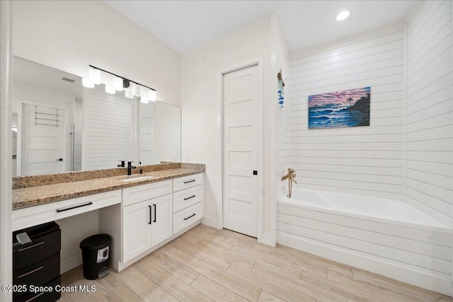 6190 Brabrook Ave, Grant, FL 32949 - full bathroom with vanity, wood finished floors, and recessed lighting