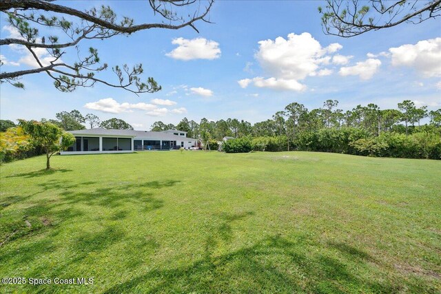 6190 Brabrook Ave, Grant, FL 32949 - view of grassy yard featuring a sunroom