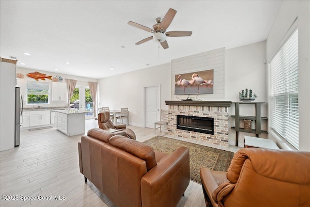 6190 Brabrook Ave, Grant, FL 32949 - living room featuring ceiling fan, a fireplace, light wood finished floors, and recessed lighting