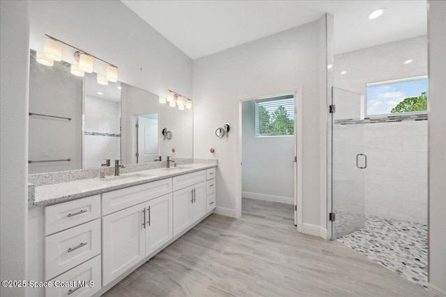 6190 Brabrook Ave, Grant, FL 32949 - bathroom with a shower stall, double vanity, wood finished floors, and recessed lighting