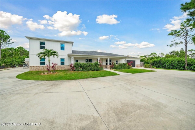 6190 Brabrook Ave, Grant, FL 32949 - view of front of property with an attached garage, concrete driveway, and a front yard