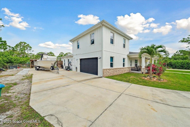 6190 Brabrook Ave, Grant, FL 32949 - view of front of house featuring driveway, a garage, board and batten siding, and a front lawn