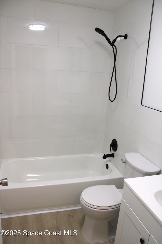 1001 Bernice Rd, Rockledge, FL 32955 - full bath featuring vanity, washtub / shower combination, and wood finished floors