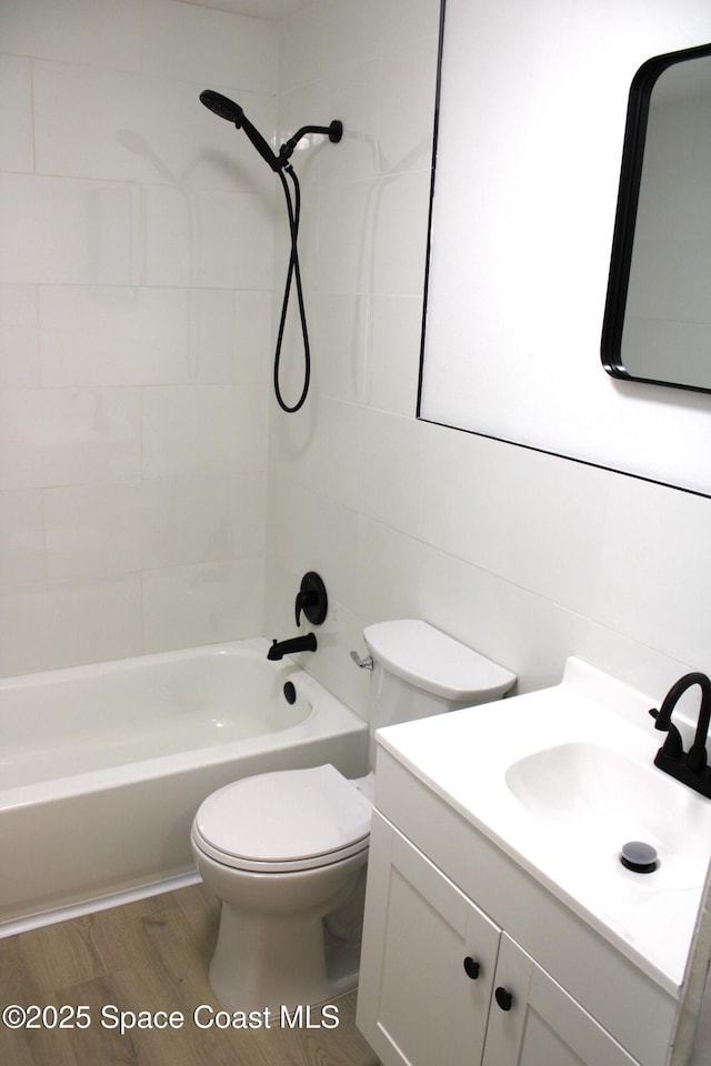 1001 Bernice Rd, Rockledge, FL 32955 - bathroom with bathtub / shower combination, vanity, and wood finished floors