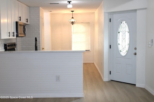 1001 Bernice Rd, Rockledge, FL 32955 - foyer entrance featuring light wood finished floors and baseboards