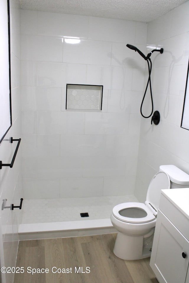 1001 Bernice Rd, Rockledge, FL 32955 - full bath with wood finished floors, a tile shower, and vanity