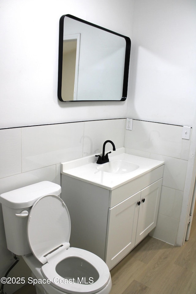 1001 Bernice Rd, Rockledge, FL 32955 - half bathroom with wood finished floors and vanity