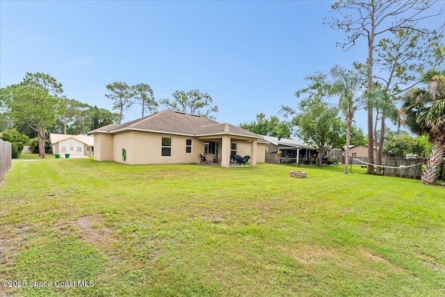 5575 Hemsing St, Cocoa, FL 32927 - rear view of property with stucco siding, a fire pit, and a fenced backyard