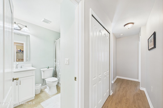 152 Clemente Dr, Satellite Beach, FL 32937 - bathroom with vanity, wood finished floors, and a closet