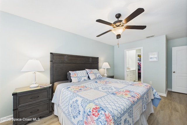 152 Clemente Dr, Satellite Beach, FL 32937 - bedroom featuring wood finished floors, ceiling fan, and connected bathroom