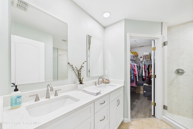 152 Clemente Dr, Satellite Beach, FL 32937 - bathroom with double vanity, a stall shower, and a spacious closet