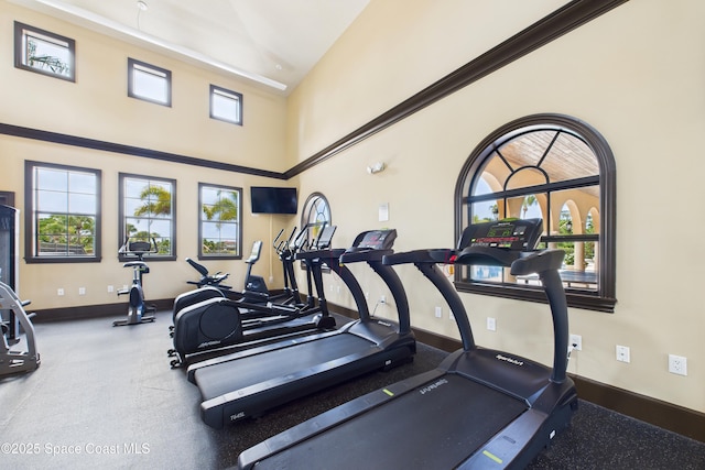 152 Clemente Dr, Satellite Beach, FL 32937 - exercise room featuring baseboards and a high ceiling