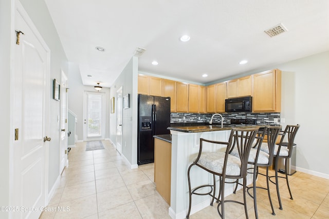152 Clemente Dr, Satellite Beach, FL 32937 - kitchen with black appliances, light brown cabinetry, backsplash, a kitchen bar, and recessed lighting
