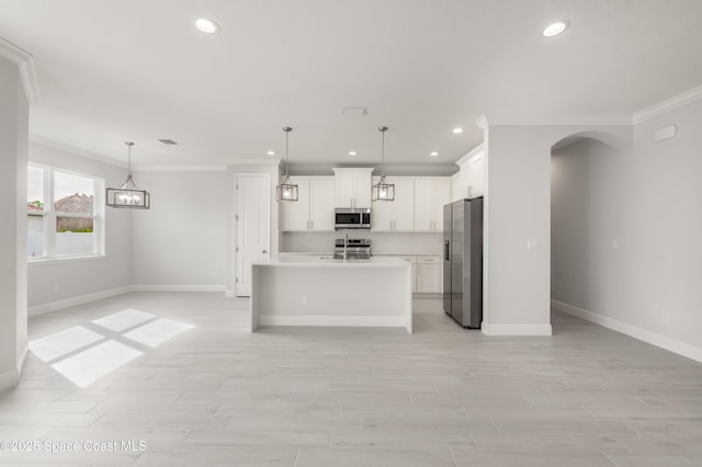 210 La Gore St, Palm Bay, FL 32908 - kitchen featuring appliances with stainless steel finishes, crown molding, open floor plan, recessed lighting, and backsplash