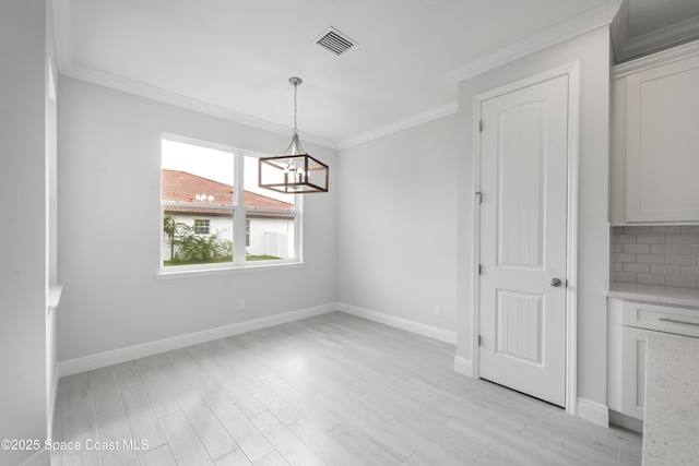 210 La Gore St, Palm Bay, FL 32908 - unfurnished dining area with ornamental molding, light wood-type flooring, and a chandelier