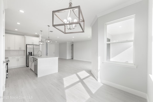 210 La Gore St, Palm Bay, FL 32908 - kitchen with tasteful backsplash, ornamental molding, light countertops, open floor plan, and white cabinets